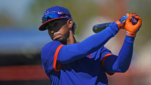 rancisco Lindor swings a bat during spring training workouts at Clover Park